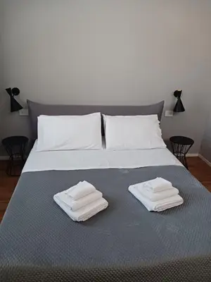 a bed with two towels on top of it at Alloro Apartment 9 in Palermo