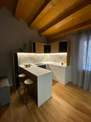 a kitchen with a white island in a room at Alloro Apartment 9 in Palermo