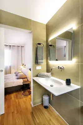 a bathroom with a sink and a bed at Alloro Apartment 9 in Palermo