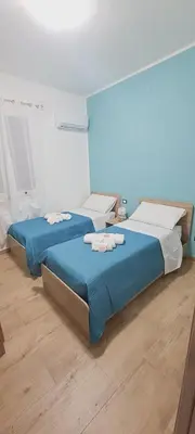a bedroom with two beds with towels on them at Perla del Mare in Trappeto
