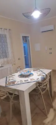 a table with a table cloth on top of it at Perla del Mare in Trappeto