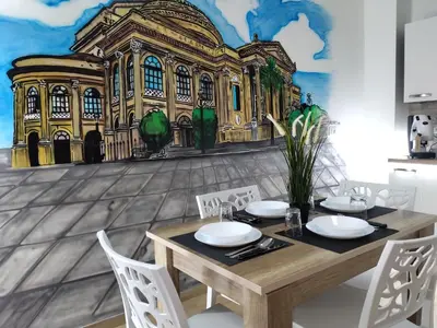 a dining room with a table and a building mural at MennulaMia in Palermo