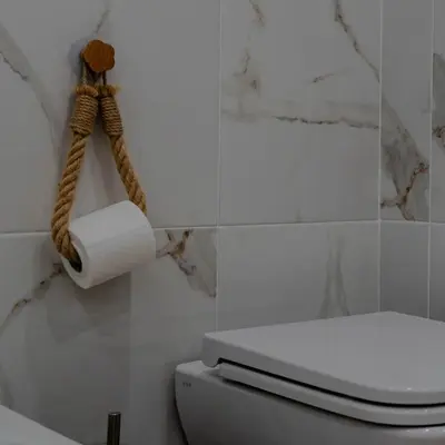 a toilet paper holder with a roll of toilet paper at MennulaMia in Palermo