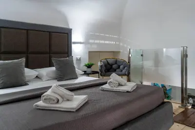 a bedroom with a large bed with towels on it at MennulaMia in Palermo