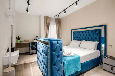a bedroom with a blue bed and a bathroom at D'ossuna66 Aquarium in Palermo