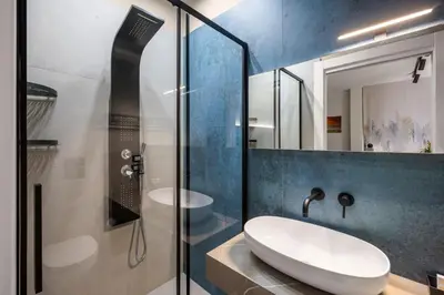 a bathroom with a sink and a glass shower at D'ossuna66 Classic in Palermo