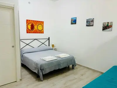 a bedroom with a bed with two towels on it at MaxMondello in Palermo