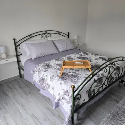 a bedroom with a bed with a wooden table on it at Villa Orlando in Trabia