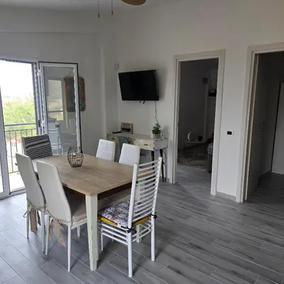 a dining room with a wooden table and chairs at Villa Orlando in Trabia
