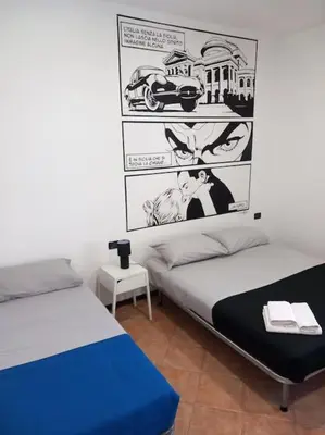 a bedroom with two beds and a poster on the wall at Piliero room in Palermo
