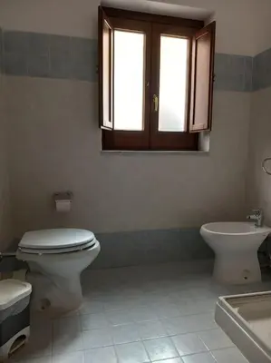 a bathroom with a toilet and a sink at Piliero room in Palermo