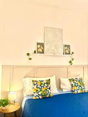 a bedroom with a blue bed with flowers on it at Michelle Holiday House in Castellammare del Golfo