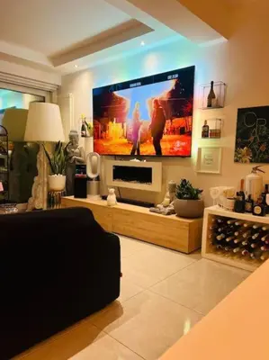 a living room with a large flat screen tv at Suite Vicino al Mare in Carini