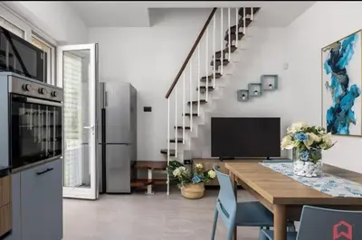 a kitchen and dining room with a table and a television at Villa Degli Ulivi in Partinico