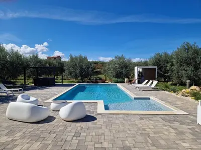 an outdoor dining room with a table and chairs at Villa Degli Ulivi in Partinico