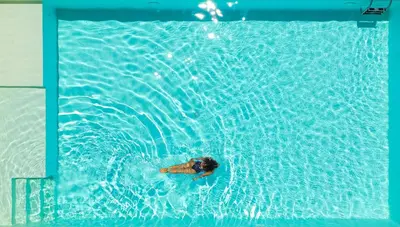 a person swimming in a swimming pool at Casa Azul in Castellammare del Golfo