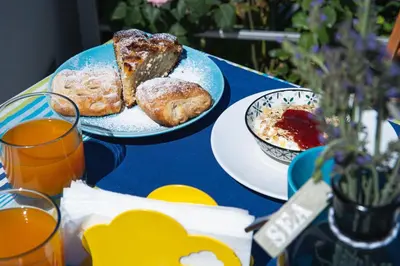 a blue table with two plates of food on it at Casa Azul in Castellammare del Golfo