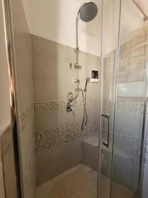 a shower with a glass door in a bathroom at Locazione Turistica Aurora in Palermo