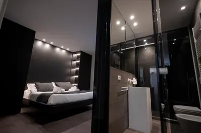 a kitchen with black cabinets and a sink at La Mia Terra Boutique Rooms in Palermo