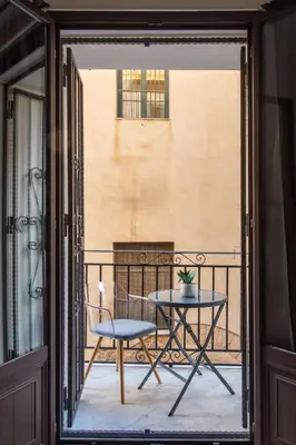 a patio with a table and chairs on a balcony at Dimore D'amare in Palermo