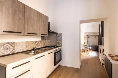 a kitchen with a sink and a stove top oven at Dimore D'amare in Palermo