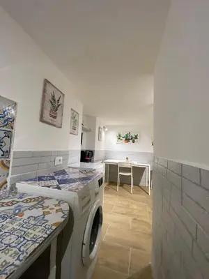 a kitchen with a washing machine in a room at Little House in Palermo