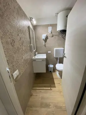 a small bathroom with a toilet and a sink at Little House in Palermo