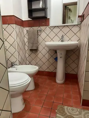 a bathroom with a toilet and a sink at Casa Vacanze Corale in Palermo