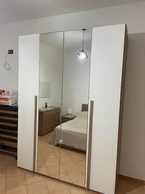 a glass partition in a bedroom with a bed at Casa Vacanze Corale in Palermo
