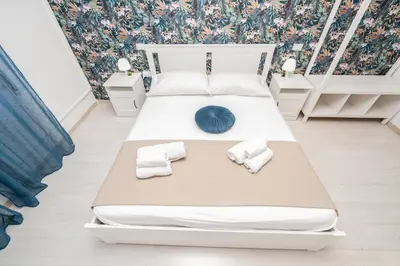a bedroom with a bed with towels on it at Central Room 128L in Palermo