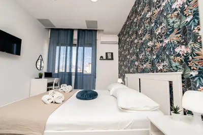 a bedroom with a bed and a floral wall at Central Room 128L in Palermo