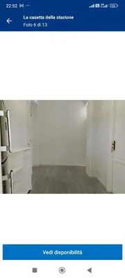 a screenshot of a website with a room with white cabinets at La casetta della stazione in Palermo