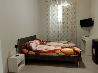 a bedroom with a bed with a blanket on it at La casetta della stazione in Palermo