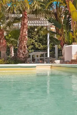 a pool of water with a gazebo and palm trees at Villa con Piscina 150mt dal Mare 8 Posti OA in Alcamo