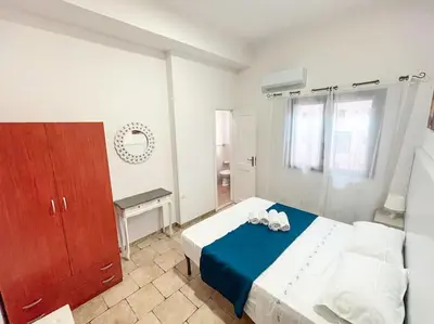 a bedroom with a blue and white bed and a desk at Villa con Piscina 150mt dal Mare 8 Posti OA in Alcamo