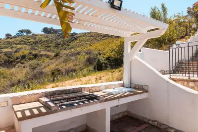 a porch with a bench with a view of a hill at Villa con Piscina 150mt dal Mare 8 Posti OA in Alcamo