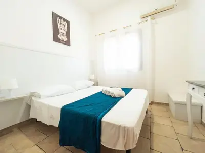 a white bedroom with a bed with a blue blanket at Villa con Piscina 150mt dal Mare 8 Posti OA in Alcamo