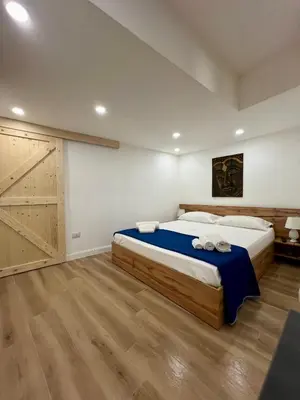 a bedroom with a large bed with towels on it at Kensia house - centro storico - stazione in Palermo