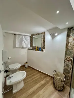 a bathroom with a toilet and a sink at Kensia house - centro storico - stazione in Palermo