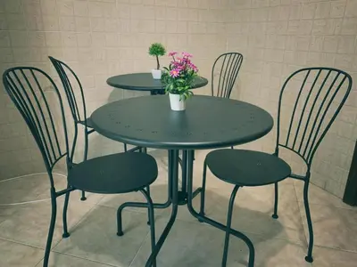 a table and chairs with flowers on top of it at Marrakech Home in Palermo