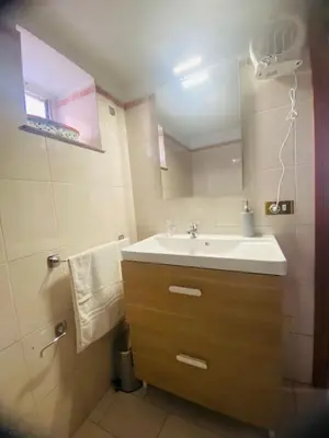 a bathroom with a sink and a mirror at Politeama House in Palermo