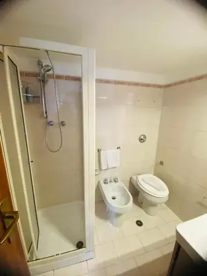 a bathroom with a toilet and a shower and a sink at Politeama House in Palermo
