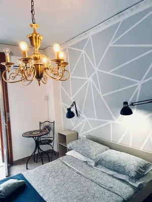 a bedroom with a bed and a chandelier at Casa di Sylwia in Termini Imerese
