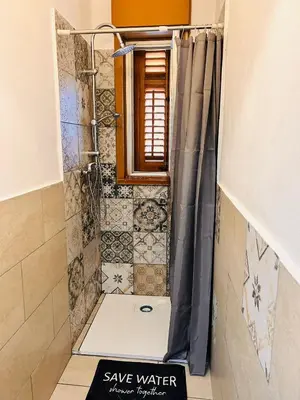 a shower with a shower curtain in a bathroom at Casa di Sylwia in Termini Imerese