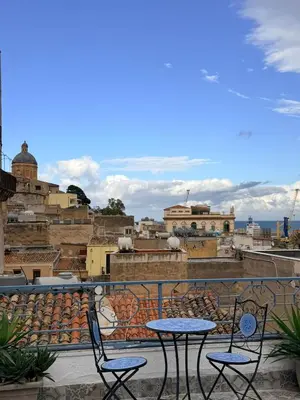 a patio with two tables and chairs on a balcony at Casa di Sylwia in Termini Imerese