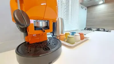 an orange mixer sitting on top of a table at Amedeo Suite - Palermo Centro in Palermo