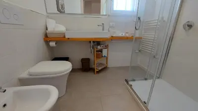 a bathroom with a toilet and a sink and a shower at Amedeo Suite - Palermo Centro in Palermo