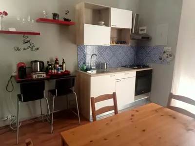 a kitchen and dining room with a table and chairs at Il balcone sulla Kalsa in Palermo