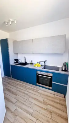 a kitchen with blue cabinets and a counter top at Villa Lilia - Private pool in Campofelice di Roccella