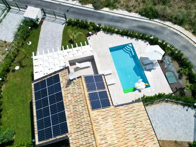 an overhead view of a swimming pool with solar panels at Villa Lilia - Private pool in Campofelice di Roccella